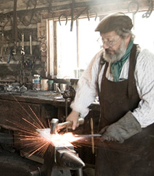 A Blacksmith hammering metal