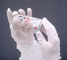 Two gloved hands holding a crumpled soda can
