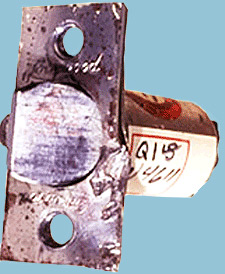 Door latch, removed from door and labeled with evidence sticker