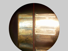 Microscopic comparison view of 2 bullets, showing a match of land and groove impressions.