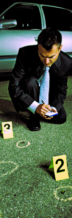 police detective making notes of marked evidence items at a crime scene in front of a car.