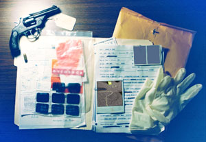 a criminal investigation case file containing photographs, laboratory reports, and inventoried items of evidence, open on a desk.