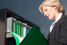 Image of woman reading a file.