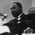 Historical portrait of Dr. Martin Luther King, Jr. giving a speech.