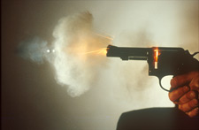 Pistol firing showing burning powder, a source of burned and partially burned smokeless powder residues 