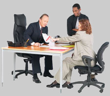 2 men, 1 woman at desk 