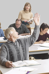 classroom with adult student raising hand