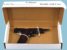 Unloaded handgun, with safety in place, secured into a carboard evidence box with zip ties.