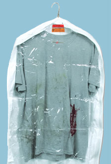 Tee shirt that is stained with blood on lower left front edge, on a clothes hanger, inside a bag.