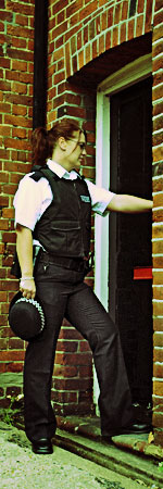 a United Kingdom Metropolitain police officer executing a search warrant.