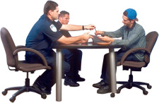 Image of police officers and suspect at a table