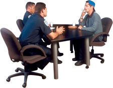 Image of police officers and suspect at a table