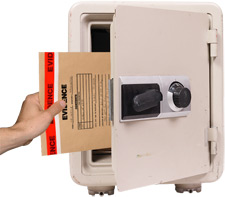 Image of evidence envelope being placed in a safe.