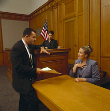 Image of counsel questioning witness in front of the judge.