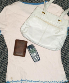 Image of purse, shirt, phone-pile of things