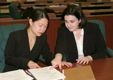 Image of two female councellors going over paperwork.
